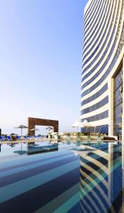 a rendering of a building with a pool at Symphony Style Hotel Kuwait in Kuwait