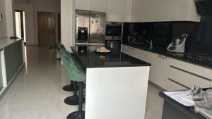 a kitchen with a black counter and appliances at Family villa: pool and panoramic view in Praia