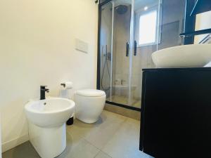 a bathroom with a toilet and a sink and a shower at Dimora del Mercante in Catania