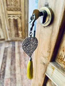 a door latch with a tassel attached to it at La Plage Onirique Beachfront Nusa Penida in Nusa Penida