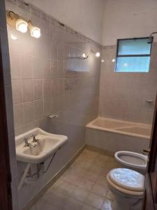 a bathroom with a sink and a toilet at El Vergel in Villa Giardino