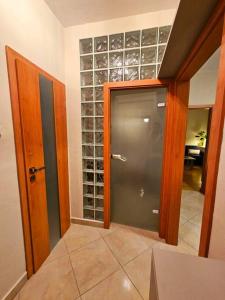 a room with a door and a glass wine cellar at Prime Location! Fan's paradise in Koliba