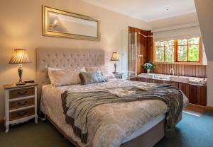 a bedroom with a large bed and a bathroom at Mountain Lodge in Mount Dandenong