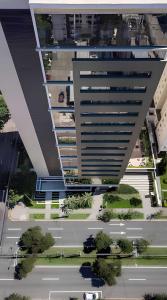 an aerial view of a tall building with a parking lot at Studio Helbor Stay Batel - Aconchegante com Vista e Localização Privilegiada in Curitiba
