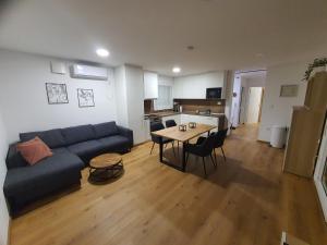 a living room with a couch and a table at Apartment Weizblick in Oberdorf bei Thannhausen