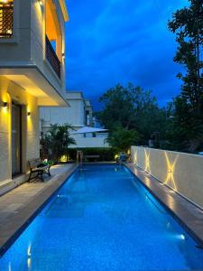 a swimming pool in front of a house at night at Villa Vista - with Pool & Jaccuzi in Kundakal