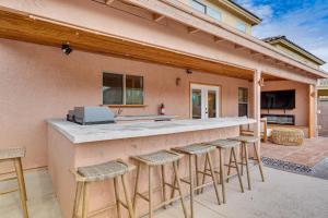 a backyard patio with a bar with stools at Gorgeous Green Valley Home Patio and Private Pool! in Green Valley