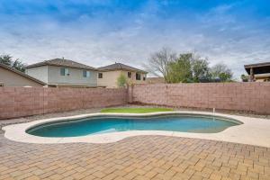 a swimming pool in front of a brick wall at Gorgeous Green Valley Home Patio and Private Pool! in Green Valley