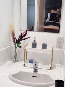 a bathroom with a sink and a mirror at Bridge House Sleeps 10 max in York, Free Parking in York