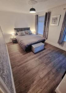 a bedroom with a bed and a wooden floor at Rise at the International Wall Belfast in Belfast