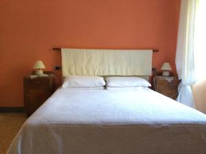 Postel nebo postele na pokoji v ubytování Agriturismo I Chiosi