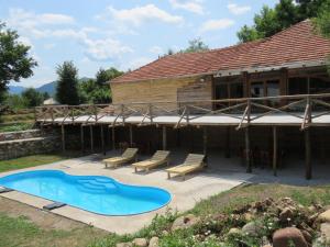 a house with a swimming pool in the yard at Etno Selo Stara Planina in Kalna