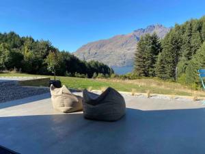 two pillows sitting on top of a roof with a mountain at Alpine Exclusive in Queenstown