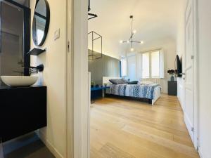 a bedroom with a bed and a sink and a mirror at Dimora del Mercante in Catania