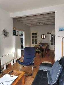 un soggiorno con sedie blu e un tavolo di La maison de Kerlois a Carnac