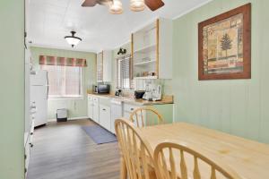 a kitchen with a table and a dining room at Lodge House-Family Cabin with Pool Table by Big Bear Vacations in Big Bear Lake