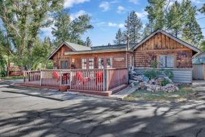 a house with a fence in front of it at Lodge House-Family Cabin with Pool Table by Big Bear Vacations in Big Bear Lake