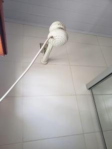 a white shower head on the wall of a bathroom at Apartamentos Pura Vida em Atlântida Sul in Xangri-lá +15 photos