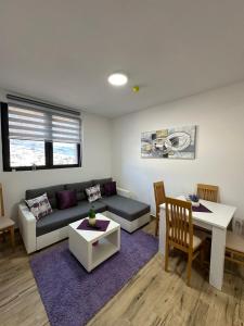 a living room with a couch and a table at Apartmani Liman Kopaonik in Kopaonik