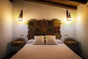 a bedroom with a large bed with two lamps at Placer de Meca in Zahora +200 photos