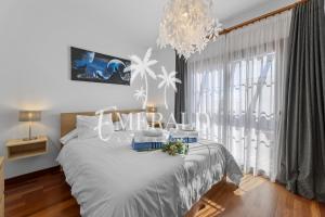 a bedroom with a bed with a chandelier at Casa del Mar - Piscina y Jacuzzi Privado in Costa Teguise +21 photos