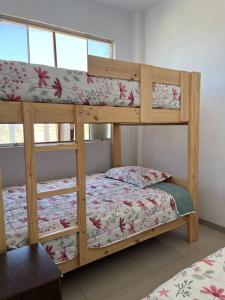 a couple of bunk beds in a room at Casa Blanca cerca al Mar in Máncora