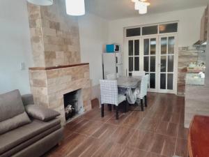 a living room with a table and a fireplace at Güemes I in San Juan