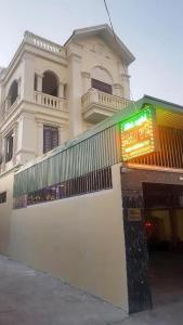 a white building with a sign in front of it at Nhà nghỉ 1061 in Hai Phong