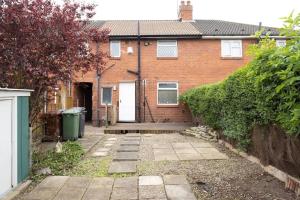 a brick house with a gate and a driveway at Origin - Close 2 city-centre, Shops, Netflix in Kirkstall