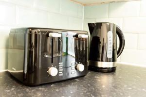 two coffeemakers sitting on a counter in a kitchen at Origin - Close 2 city-centre, Shops, Netflix in Kirkstall
