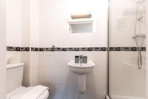 a bathroom with a toilet and a sink and a shower at Zircon - 2 Bed Flat with Parking in Southampton