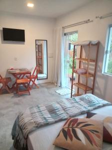 a bedroom with a bed and a table and chairs at Wayak Flats PDR in Imbituba