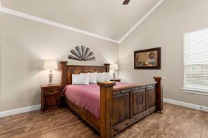 a bedroom with a wooden bed in a room at River Road Villas #2 in New Braunfels