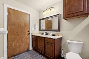 a bathroom with a sink and a toilet and a mirror at River Road Villas #2 in New Braunfels +42 photos