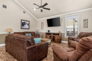 a living room with couches and a flat screen tv at River Road Villas #2 in New Braunfels