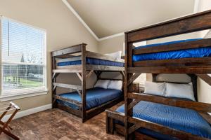 two bunk beds in a room with a window at River Road Villas #2 in New Braunfels