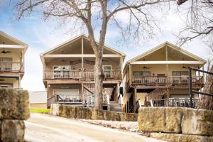 a building with balconies and trees in front of it at River Road Villas #2 in New Braunfels