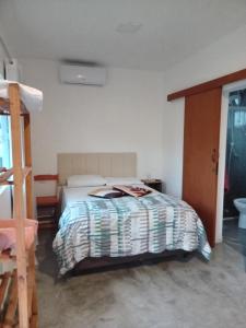 a bedroom with a bed and a ladder at Wayak Flats PDR in Imbituba +16 photos