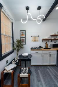 a kitchen with white cabinets and a table at Saint Philip Residence in New Orleans