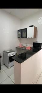 a kitchen with a counter top and a stove at AP térreo Ilhéus in Ilhéus
