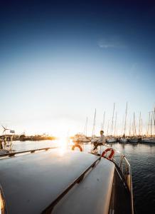 a man sitting on a boat in the water at Alojamiento en Barco Oasis in Valencia