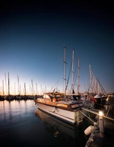 a group of boats docked in a harbor at night at Alojamiento en Barco Oasis in Valencia