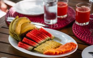 a plate of fruit and vegetables on a table at C Beyond Nilaveli in Nilaveli