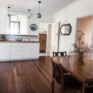 a kitchen and dining room with a wooden table at Gum Grove Chalets in Denmark