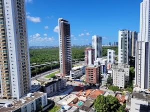 an aerial view of a city with tall buildings at Flat Beach Class Recife in Recife