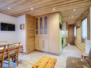 a living room with a table and a kitchen at La Ruche RU0490 in La Clusaz