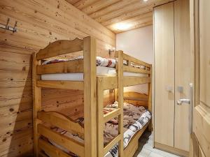 a log cabin bedroom with two bunk beds at La Ruche RU0490 in La Clusaz