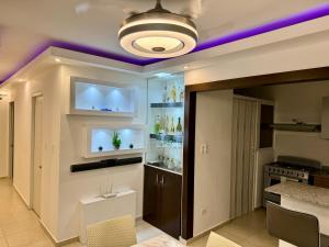 a kitchen with a ceiling with purple lighting at Moderno Penthouse 