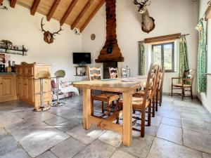 uma sala de jantar com uma mesa de madeira e cadeiras em Gîte authentique -Mont Lozère em Les Bondons