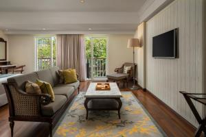 a living room with a couch and a tv at Maison Aurelia Sanur, Bali - By Préférence in Sanur